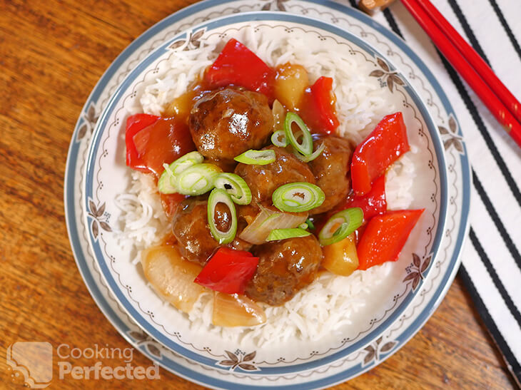 Sweet and sour meatballs with pineapple served on steamed rice