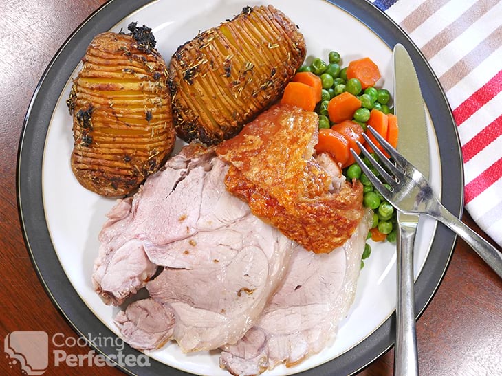 Air-fried pork roast with crackling, potatoes, and vegetables
