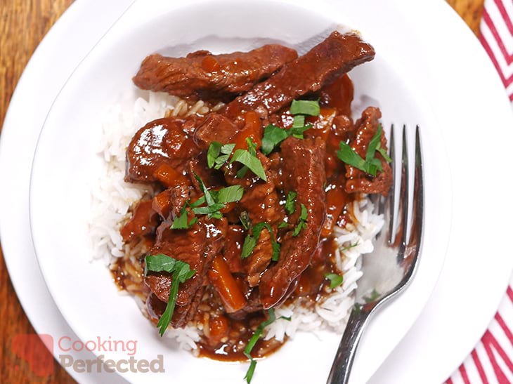 Mongolian Beef served with rice and topped with parsley