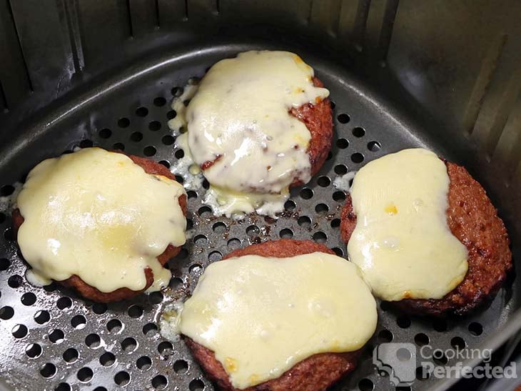 Hamburgers topped with cheddar cheese in the air fryer