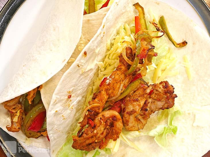 Air-Fried Chicken Fajitas in a tortilla with lettuce, cheddar cheese, and sour cream.