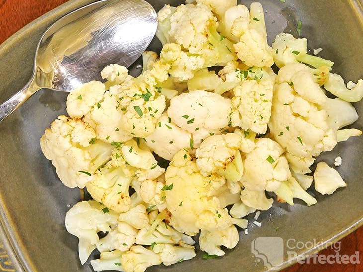 Cauliflower cooked in the air fryer and garnished with chopped parsley.