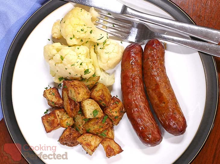 Air-fried beef sausages with cauliflower and roast potatoes